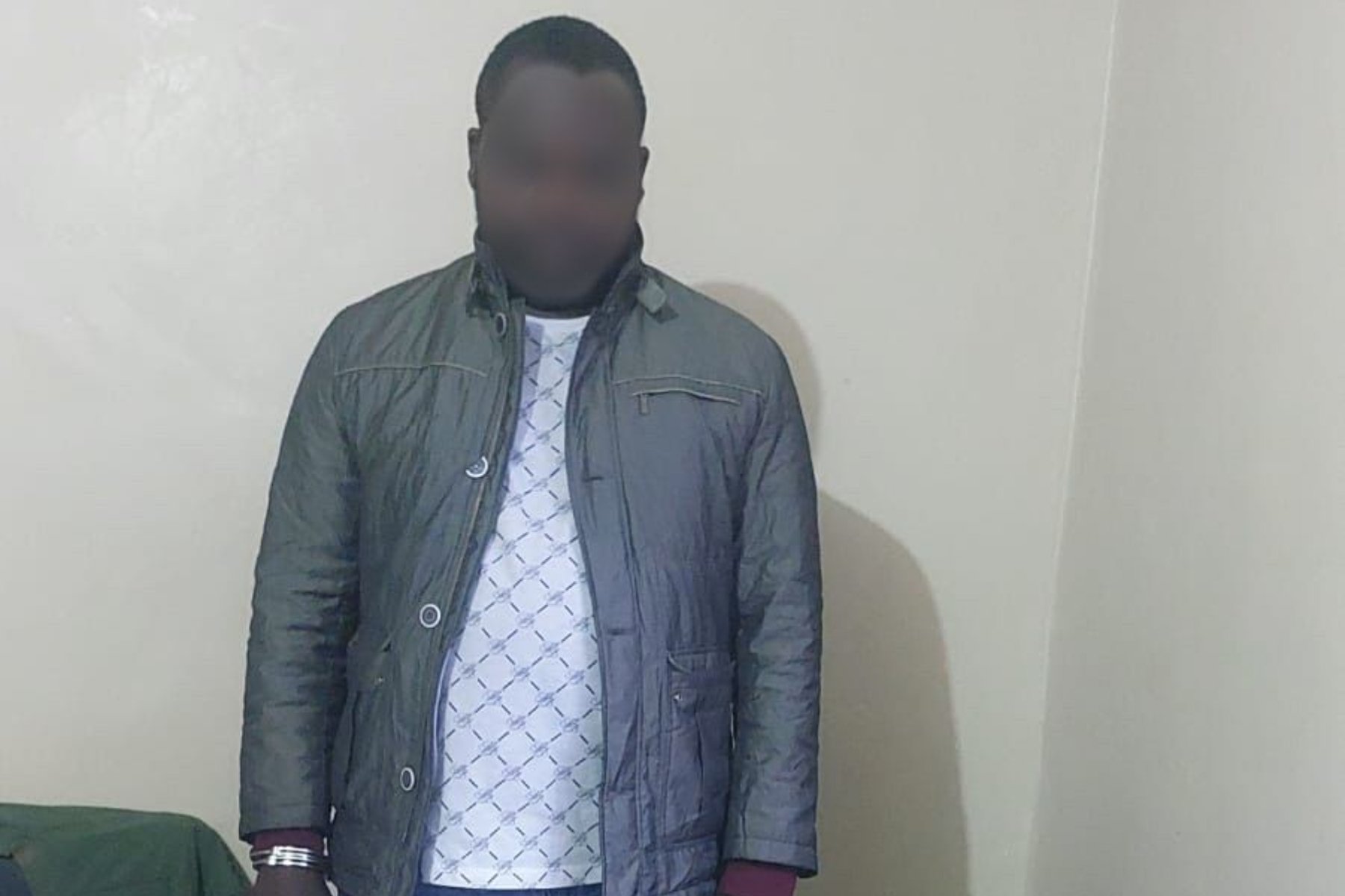 Photo of suspect arrested with stolen phones and laptops in Nairobi.